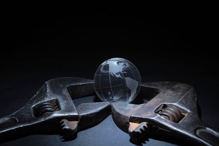 Rusty spanners with little glassy globe on dark backgroundの写真素材