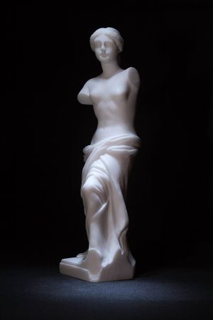 Miniature copy of Venus statue standing on dark backgroundの写真素材