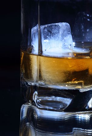 Close-up of whiskey with ice on dark backgroundの写真素材