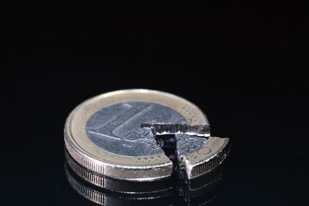 Euro coin and coin's part lying on dark backgroundの写真素材