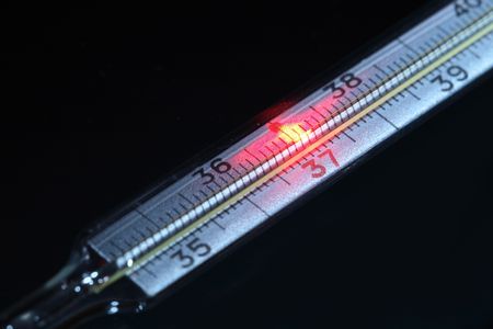 Celcius thermometer with red fire point near thirty seven numeral