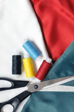 Background with scissors threads and variegated clothes