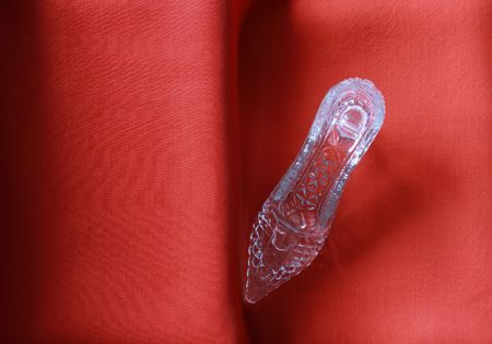 Nice glass slipper standing on stairs with red clothの写真素材