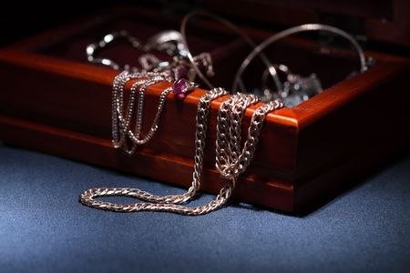 Close-up of wooden casket with jewelry on dark backgroundの写真素材