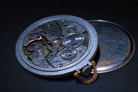 Close-up of old watch mechanism on dark background