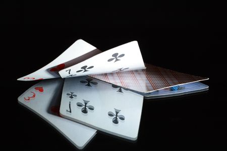 Two opened cards and one closed playing card on dark backgroundの写真素材