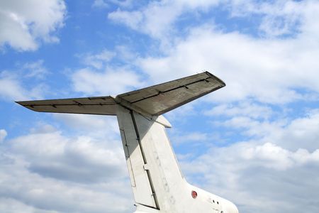 Close-up of airplane empennage group isolated on blue sky background