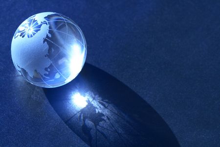 Blue glass globe with reverberation on dark background for your notesの写真素材