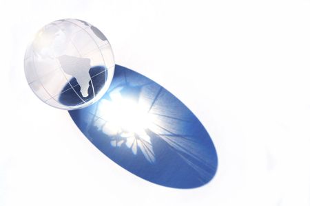 Glass globe with long dark shadow isolated on white backgroundの写真素材