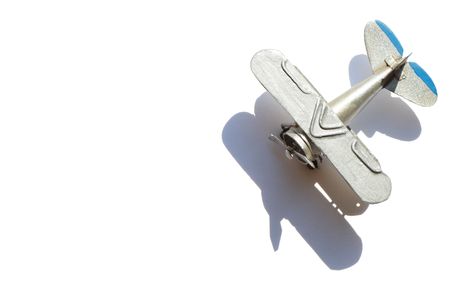Metal miniature model of old biplane isolated on white background の写真素材