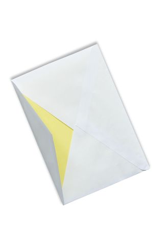 Yellow paper inside open envelope.の写真素材