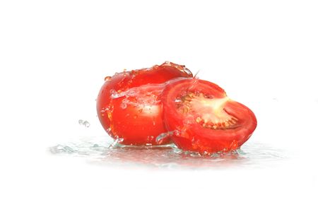 Two fresh tomatoes under water drops isolated on white background の写真素材