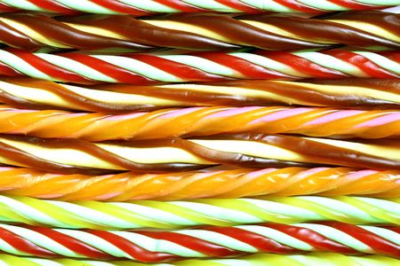 Multi-color twisted liquorice candy in blue, red, green, orange, and pinkの写真素材