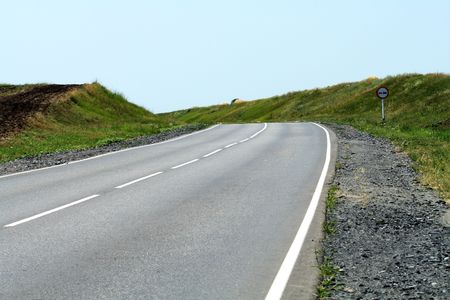 Landscape with empty country highway on blue sky backgroundの写真素材