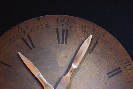 Closeup of old rusty bronze clock dial. Clock hands made from sharpen steel scalpelsの写真素材