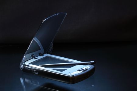 Modern personal date assistant and stylus isolated on dark backgroundの写真素材