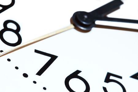 Extreme closeup of clock dial on white background with copy spaceの写真素材