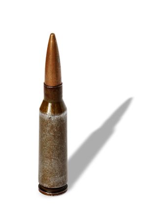 Old rifle cartridge standing on white background isolated の写真素材