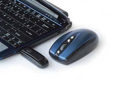 Wireless computer mouse lying near laptop isolated on white backgroundの写真素材