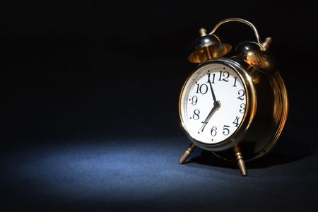 Nice alarm clock on dark background with copy spaceの写真素材