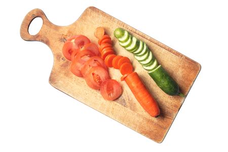 Various sliced vegetables on wooden breadboard. の写真素材