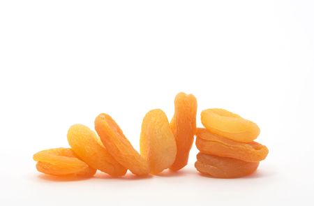 Ginger dried apricots lying in a row on white backgroundの写真素材