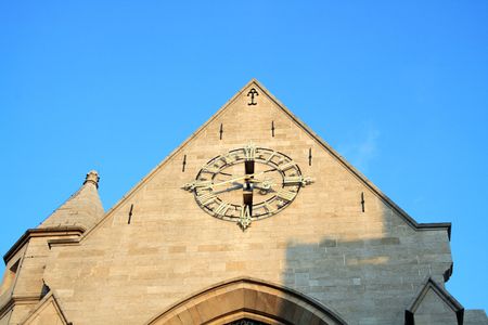 Antique clock at the chirch wall on blue sky backgroundの写真素材