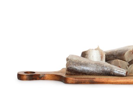 Sliced raw fish lying on wooden cutting board.の写真素材