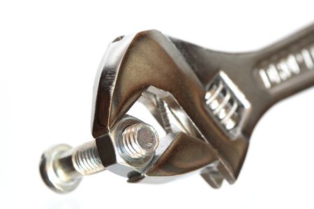 Extreme closeup of adjustable wrench and screw nut on white backgroundの写真素材