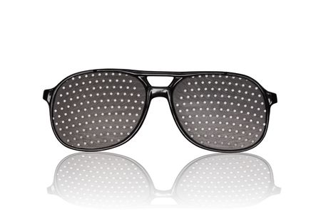 Black punched eyeglasses for vision training. Isolated on white の写真素材