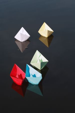 Set of motley paper boats on water background.の写真素材