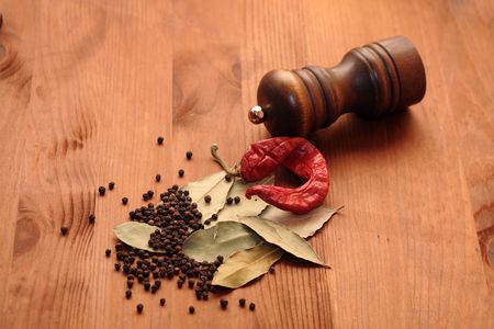 Still life with various spice near pepper mill on wooden backgroundの写真素材