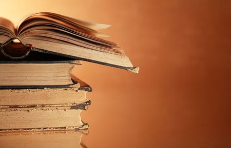 Stack of very old books on nice gradient background with reverberation and copy spaceの写真素材