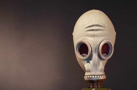 Old gas mask standing on dark background with copy spaceの写真素材