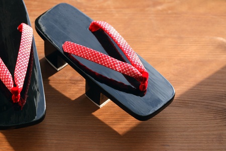Pair of traditional japanese geta sandal on wooden surfaceの写真素材