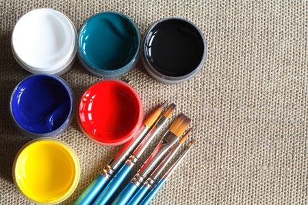 Set of paintbrushes and color paint on canvas backgroundの写真素材