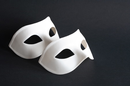Two white venetian masks on black backgroundの写真素材