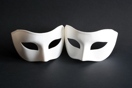 Two white venetian masks on dark backgroundの写真素材