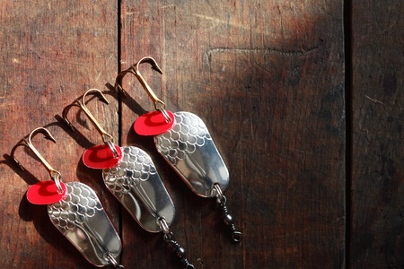 Three spinners lying in a row on wooden surface with copy spaceの写真素材