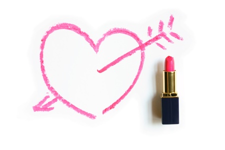 Red lipstick near painted heart and love arrow on white backgroundの写真素材