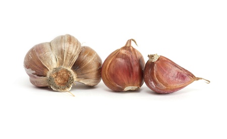 Few cloves of garlic on white backgroundの写真素材
