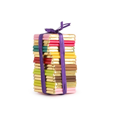 Stack of small chocolate bars tied up with blue band. Isolated on whiteの写真素材