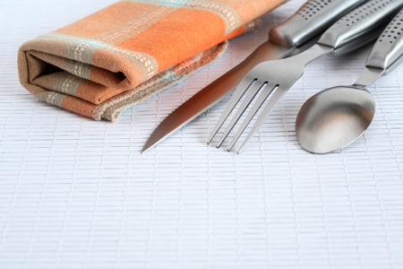 Closeup of cover set near checkered napkinの写真素材