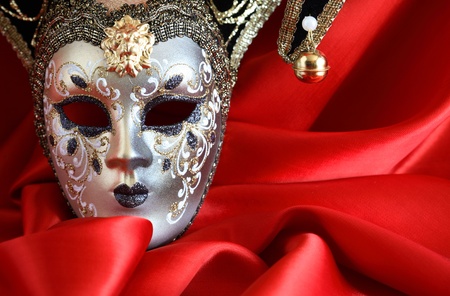 Closeup of classical venetian mask on red silk background with free space for textの写真素材
