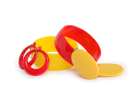 Colored plastic bangles and earrings on white background. Isolated with clipping pathの写真素材