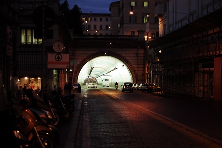 Night urban scene with cars driving through a glowing tunnelの写真素材