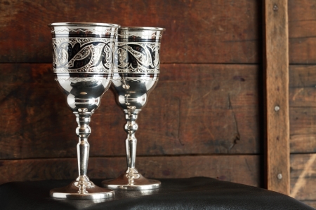 Pair of nice vintage silver goblets on old wooden backgroundの写真素材