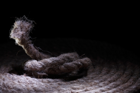 Skein of old hemp rope on dark background with free space for textの写真素材