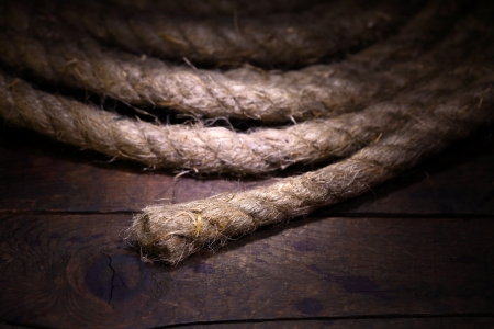 Skein of old hemp rope on dark wooden surfaceの写真素材