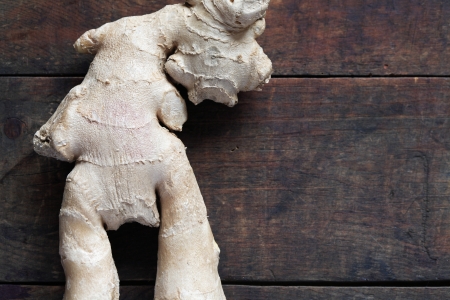Closeup of ginger root on dark wooden surface